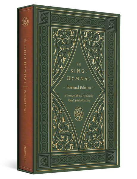 The Sing! Hymnal Personal Edition book shown at a three-quarter angle, featuring a dark green front cover with ornate gold embossed floral and geometric designs, and a brown spine with gold text.
