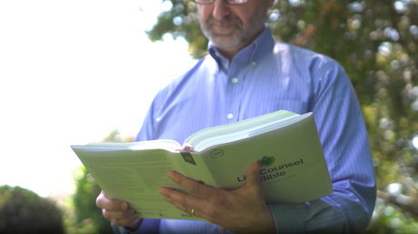Man reading CSB Life Counsel Bible, Hardcover: Practical Wisdom for All of Life outdoors