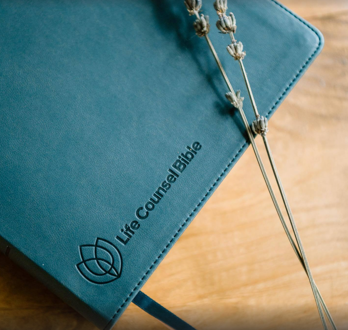 Close-up of the debossed cover of CSB Life Counsel Bible, Slate Blue Leathertouch: Practical Wisdom for All of Life